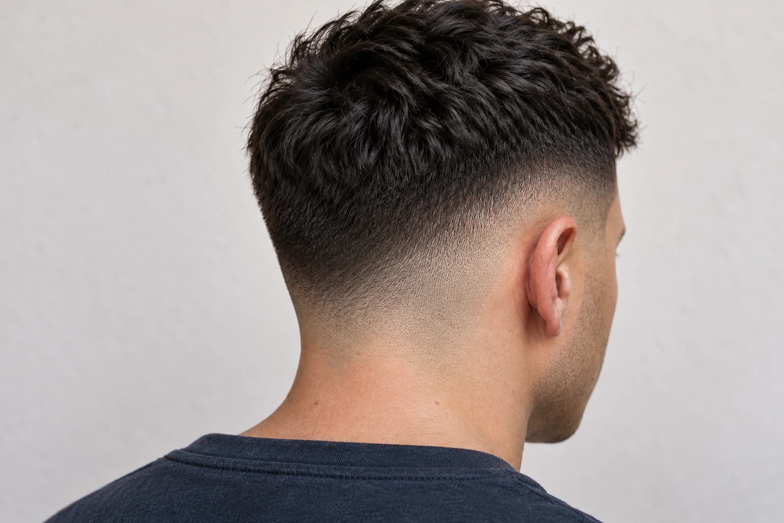 Close-up of a finished skin fade with natural hair and skin texture